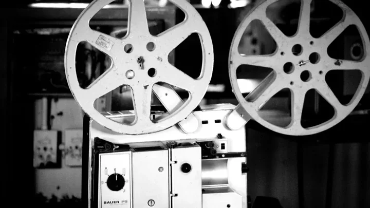 Vintage film projector and reels photographed in black and white